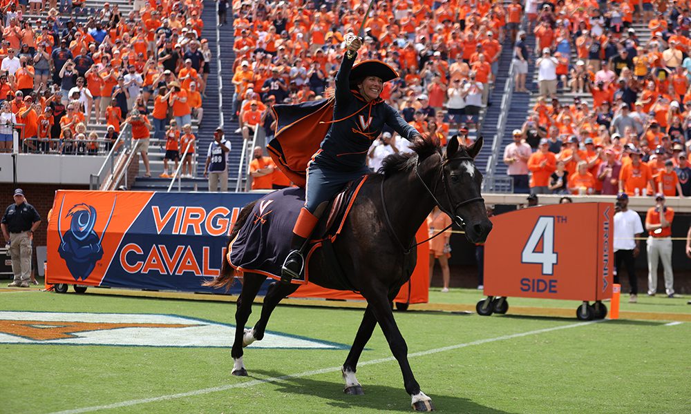 cavalier woman riding on horse in football stadium